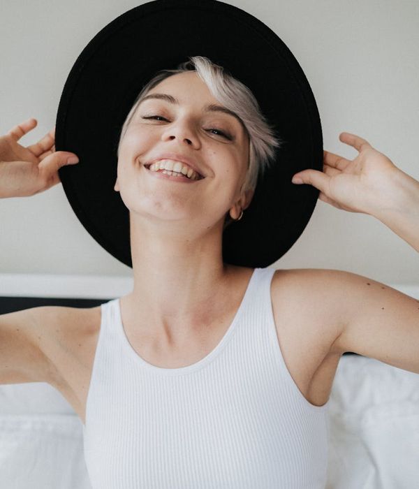 Woman feeling energetic and full of life in a bright room.